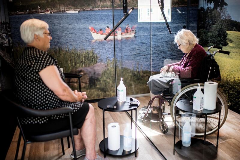 Two elderly women meet in a so-called "Heart Room" installed on the grounds of the Humlehaven nursing home in Arslev on the island of Funen, Denmark.  AFP