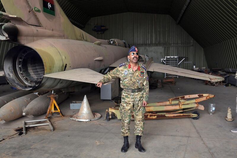 Group Captain Muhammad Qanunu, military spokesperson of the Government of National Accord (GNA) forces, stands by a partially disassembled MiG 23 aircraft, after seizing Al-Watiya airbase, southwest of the capital Tripoli, on May 18, 2020. Libya's UN-recognised government scored another battlefield victory Monday against strongman Khalifa Haftar, capturing the key rear base used by his fighters in a conflict now in its second year. Haftar, who controls swathes of eastern Libya, launched an offensive in April last year against the capital Tripoli, seat of the UN-recognised Government of National Accord (GNA). / AFP / Mahmud TURKIA
