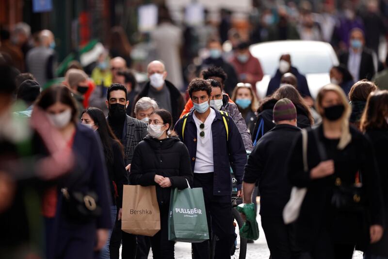 People wearing protective masks walk in the Montorgueil street in Paris, France. Reuters