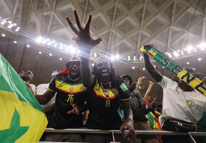 Senegal fans burst into rapturous celebrations in the stands as their team secure their first points of the World Cup. Reuters