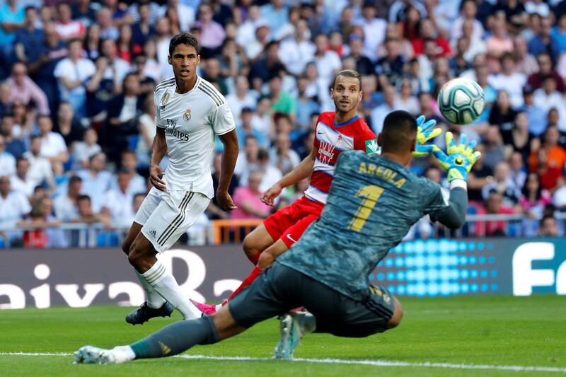 Real Madrid's Raphael Varane sees his shot saved by Granada goalkeeper Alphonse Areola. EPA