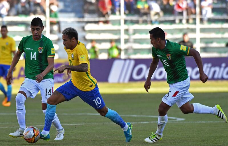 Neymar breaks away from Bolivia's Raul Castro, left, and Christian Machado. Nelson Almeida / AFP