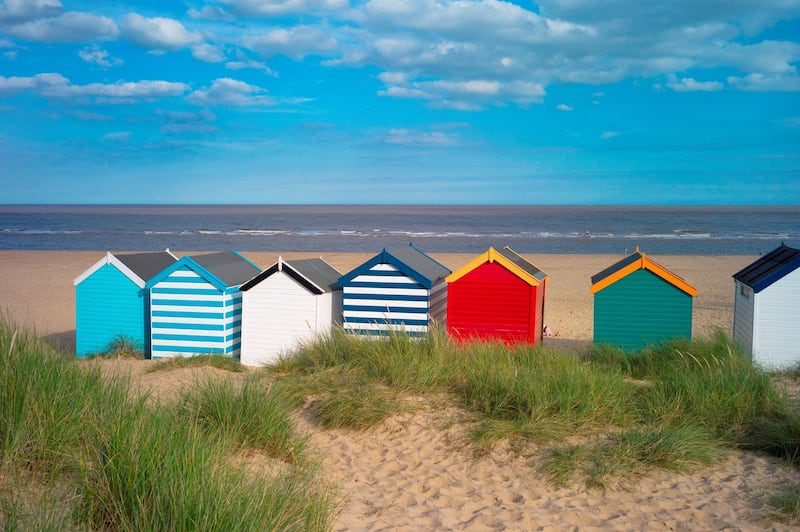 England. Suffolk. Southwold. Group of brightly coloured beach huts near Gun Hill. (Photo by: Bob Battersby/Eye Ubiquitous/Universal Images Group via Getty Images)