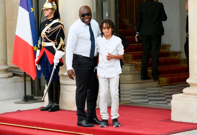 France's forward Kylian Mbappe's father Wilfried Mbappe (L) and brother Ethan Mbappe  arrive for a reception at the Elysee Presidential Palace on July 16, 2018 in Paris after French players won the Russia 2018 World Cup final football match. France celebrated their second World Cup win 20 years after their maiden triumph on July 15, 2018, overcoming a passionate Croatia side 4-2 in one of the most gripping finals in recent history. / AFP / Lionel BONAVENTURE

