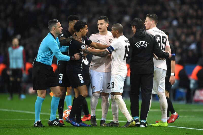 PARIS, FRANCE - MARCH 06: Marquinhos of PSG and Ashley Young of Manchester United clash  during the UEFA Champions League Round of 16 Second Leg match between Paris Saint-Germain and Manchester United at Parc des Princes on March 06, 2019 in Paris, . (Photo by Shaun Botterill/Getty Images)