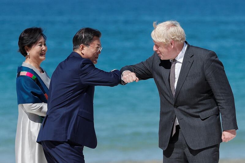 Britain's Prime Minister Boris Johnson greets South Korea's President Moon Jae-in. AFP
