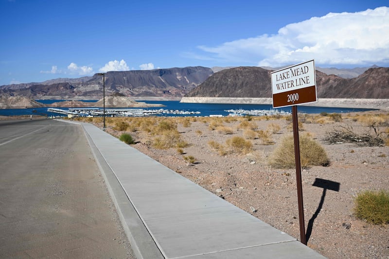 A sign indicates the Lake Mead waterline in 2000 in contrast to current low water levels. AFP