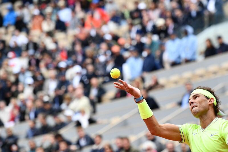 Nadal serves against Federer. AFP