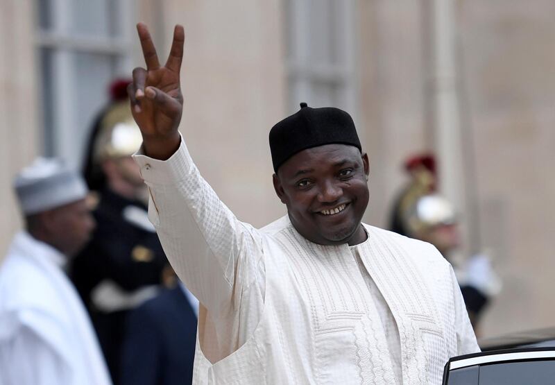 Gambian President Adama Barrow gestures as he leaves after his meeting with the French President at the Elysee Presidential Palace in Paris on March 15, 2017.  / AFP PHOTO / STEPHANE DE SAKUTIN