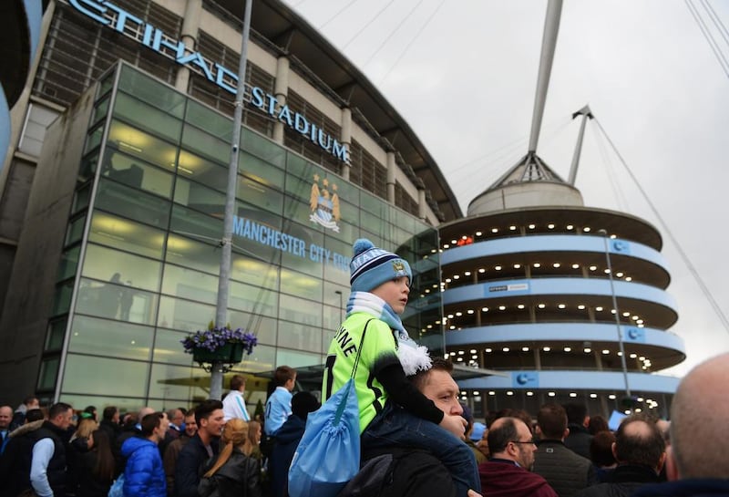Fans wait for players' arrival prior to a match between Abu Dhabi-owned Manchester City and West Bromwich Albion at the Etihad Stadium in April. Middle East investment has helped to spur City to the top ranks of the English Premier League. Gareth Copley/Getty Images