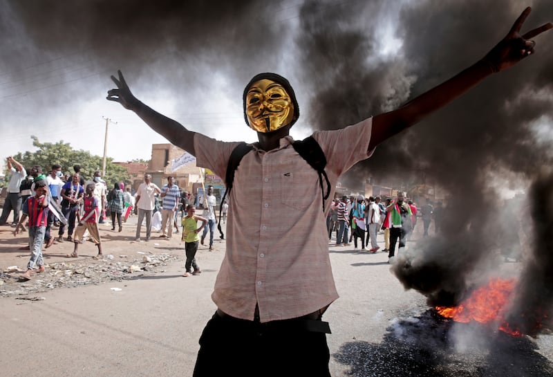 A man flashes the victory sign during a protest in Khartoum to denounce the October 2021 military coup in Sudan. AP
