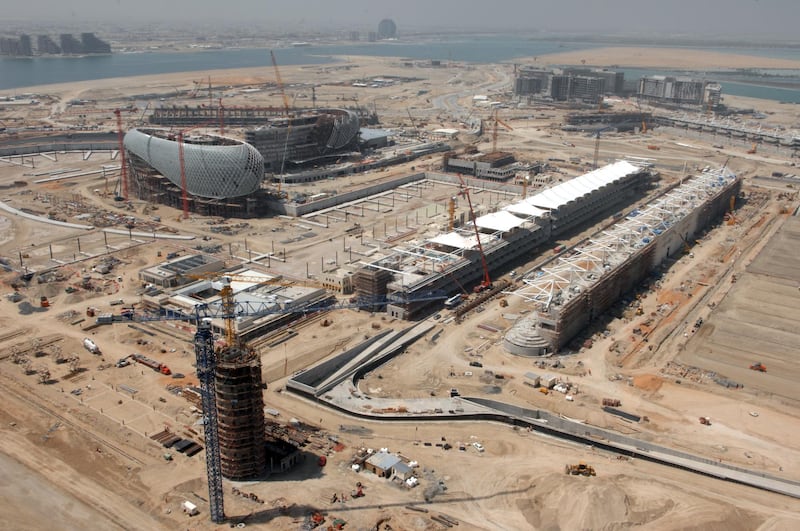 Canopies begin to be hung up over the start and finish line as the outer shell of Yas Viceroy Hotel is built in 2009. Construction for a complex of hotels to the left of the Viceroy is also under way.