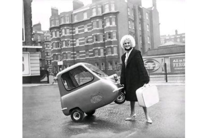 Karen Burch, 20, of Upminster shows how easy it is to park the world's smallest car, the Peel P.50.