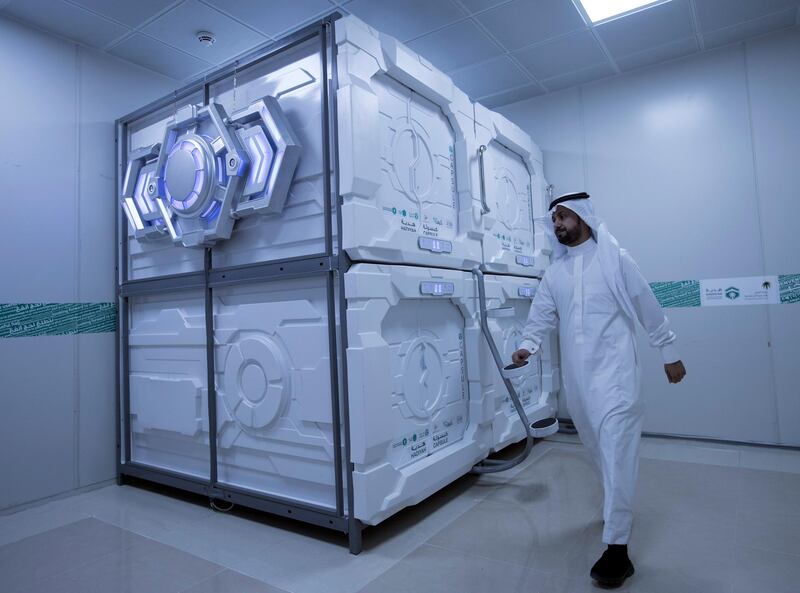 epa06955420 A hajj pilgrim exits his capsule room in Mecca, Saudi Arabia, 16 August 2018 (issued 18 August 2018). Hajj season pilgrims will be able to try out the latest mobile hotel capsules - sleeping units that offer hotel room services and facilities in the smallest possible space, Hadiyah, the Hajji and Muâ€™tamerâ€™s Gift Charitable Association has announced.  EPA/SEDAT SUNA