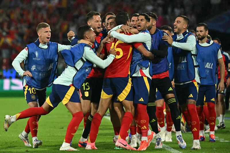 Spain's Rodri, No 16, celebrates scoring his team's equaliser with teammates. AFP