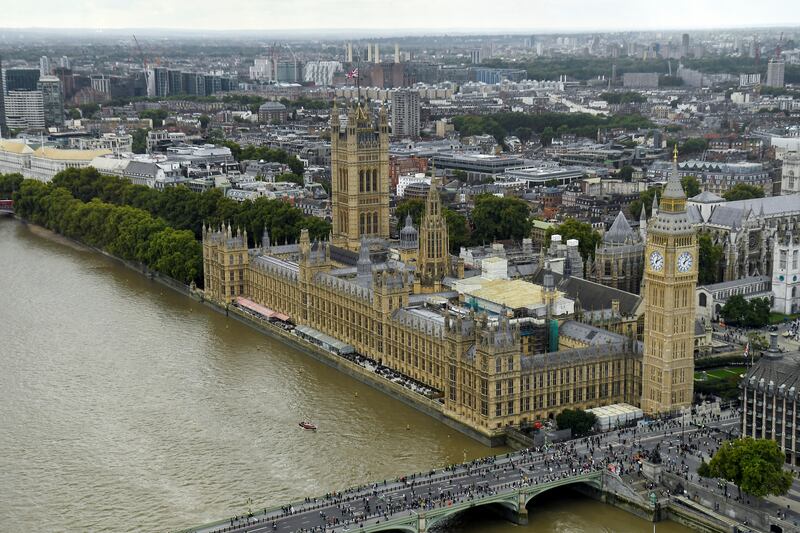 People queue on a bridge over the river Thames, next to the Palace of Westminster. Reuters