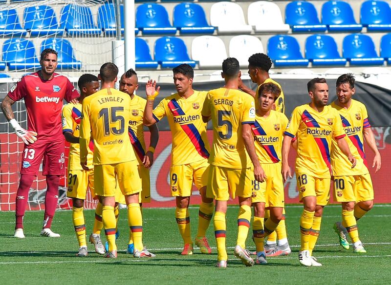 Luis Suarez (C) celebrates with teammates after scoring Barcelona's third goal against Alaves. AFP