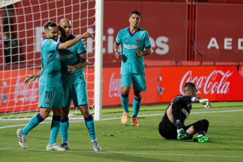 Barcelona's Jordi Alba, left, celebrates after scoring his side's third goal against Mallorca. AP Photo