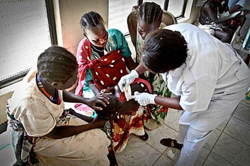 A Murle child is treated for a wound at Juba Teaching Hospital in South Sudan's capital of Juba, last week. The child was injured during attacks by the Lou Nuer. Both tribes are from the country's Jonglei state .