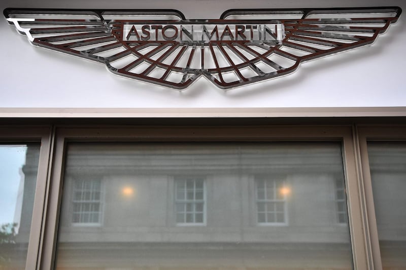 (FILES) In this file photo taken on August 29, 2018 Signage on the front of an Aston Martin showroom in central London on August 29, 2018.  The Racing Point Formula One team will be rebranded Aston Martin from 2021, James Bond's favourite carmaker said Friday after securing a large cash injection to get back on track. / AFP / BEN STANSALL
