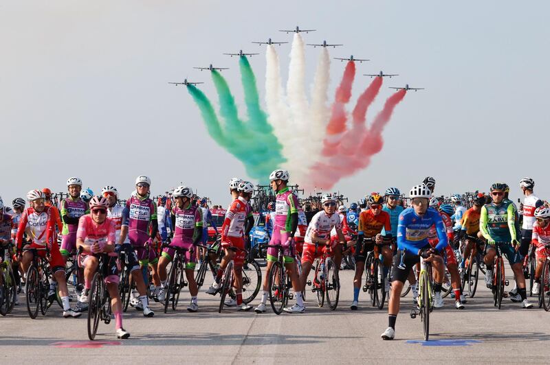 Cyclists wait as Italian Air Force acrobatic unit Frecce Tricolori perform ahead of Stage 15 of the Giro d'Italia, a 185-kilometer route between Base Aerea Rivolto and Piancavallo, on Sunday, October 18. AFP
