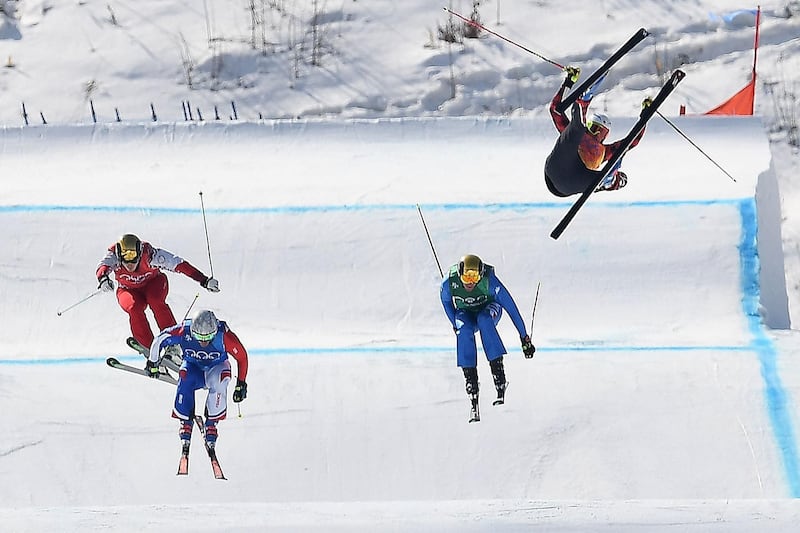 Canada's Christopher Delbosco, right, falls as France's Francois Place, second left. leads the men's ski cross quarter-final heat. Loic Venance / AFP Photo
