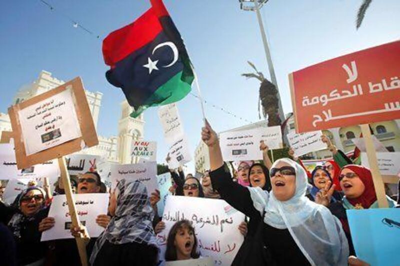 Pro-government protesters rally against the use of violence after gunmen seized control of two government ministries.