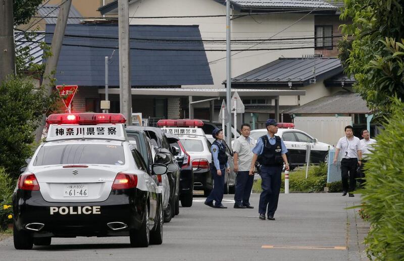 Japanese police officers check around the care home. Kimimasa Mayama / EPA