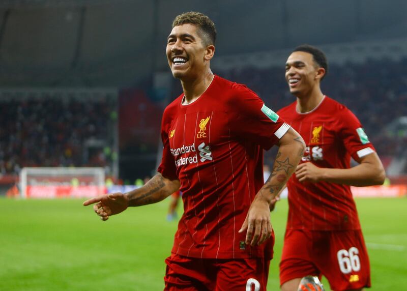 Liverpool's Roberto Firmino, left, celebrates after a goal after the Club World Cup semifinal soccer match between Liverpool and Monterrey at the Khalifa International Stadium in Doha, Qatar, Wednesday, Dec. 18, 2019. (AP Photo/Hussein Sayed)