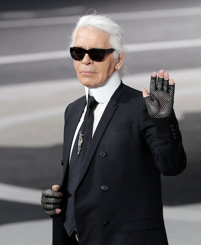 FILE - In this Tuesday, March, 5, 2013 file photo, Karl Lagerfeld acknowledges applause at the end of his Fall/Winter 2013-2014 ready to wear collection for Chanel presented, in Paris. Chanel's iconic couturier, Karl Lagerfeld, whose accomplished designs as well as trademark white ponytail, high starched collars and dark enigmatic glasses dominated high fashion for the last 50 years, has died. He was around 85 years old. (AP Photo/Christophe Ena, File)