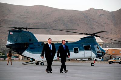 Secretary of State Mike Pompeo, left, walks from a helicopter with U.S. Ambassador to Afghanistan John Bass, Tuesday, June 25, 2019, as Pompeo returns to his plane after an unannounced visit to Kabul, Afghanistan. (AP Photo/Jacquelyn Martin, Pool) / AFP / POOL / Jacquelyn Martin

