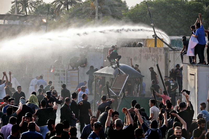 Security forces use water cannon to prevent supporters of the Co-ordination Framework from entering the Green Zone. AFP