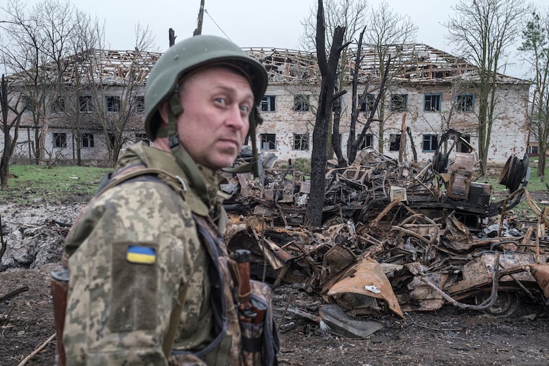 Leonid Serdiuchenko, a Ukrainian commander, stands next to destroyed vehicles outside Barvinkove. Reuters