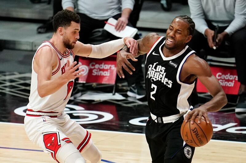 Los Angeles Clippers forward Kawhi Leonard, right, is fouled by Chicago Bulls guard Zach LaVine during the second half of an NBA basketball game Sunday, Jan. 10, 2021, in Los Angeles. (AP Photo/Marcio Jose Sanchez)