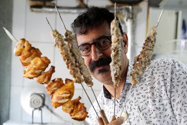 DUBAI , UNITED ARAB EMIRATES , January 9 ��� 2019 :- Majeed Al Ustad , owner holding different types of kabab���s at the Ustad Special Kabab Iranian restaurant in Bur Dubai in Dubai. ( Pawan Singh / The National ) For News. Story by Nick Webster