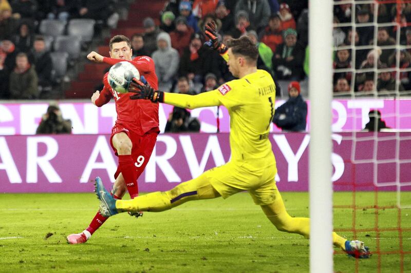 MUNICH, GERMANY - DECEMBER 14: Robert Lewandowski of FC Bayern Muenchen scores his sides fourth goal during the Bundesliga match between FC Bayern Muenchen and SV Werder Bremen at Allianz Arena on December 14, 2019 in Munich, Germany. (Photo by Adam Pretty/Bongarts/Getty Images)