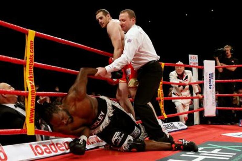 British and Commonwealth champion David Price knocks down Audley Harrison during their title fight in Liverpool, England.