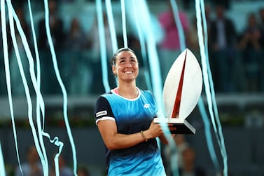 MADRID, SPAIN - MAY 07: Ons Jabeur of Tunisia celebrates with the trophy following victory during the Women's Singles final match against Jessica Pegula of the United States during day ten of Mutua Madrid Open at La Caja Magica on May 07, 2022 in Madrid, Spain. (Photo by Clive Brunskill / Getty Images)