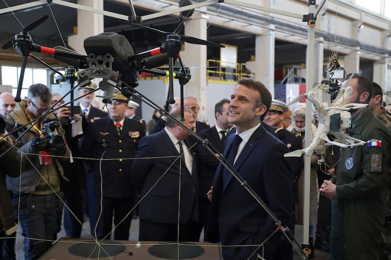 President Macron views drones as he meets Paris 2024 surveillance officers at Cherbourg Naval Base. AP