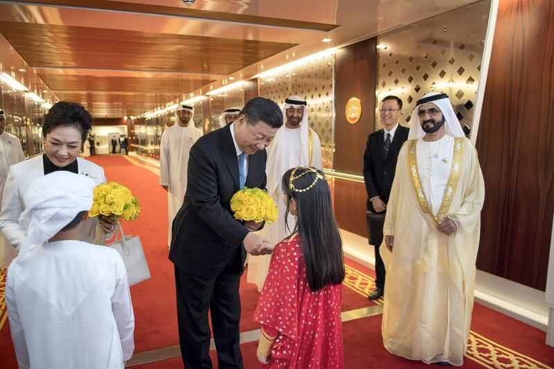 ABU DHABI, UNITED ARAB EMIRATES - July 19, 2018: HE Xi Jinping, President of China (C) is presented with flowers upon his arrival at the Presidential Airport. Seen with HH Sheikh Mohamed bin Rashid Al Maktoum, Vice-President, Prime Minister of the UAE, Ruler of Dubai and Minister of Defence (R) and HH Sheikh Mohamed bin Zayed Al Nahyan, Crown Prince of Abu Dhabi and Deputy Supreme Commander of the UAE Armed Forces (back 2nd R), and Peng Liyuan, First Lady of China (back L).

( Saif Al Muhairi / Government of Dubai Media Office )
---