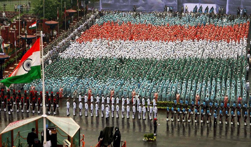 Indian Prime Minister Manmohan Singh, bottom left, speaks from a bullet proof podium as schoolchildren in colored clothing make a formation that resembles the Indian flag, background, during celebrations of India's Independence Day at the Red Fort monument in New Delhi, India, Monday, Aug. 15, 2011. India marked 64 years of independence from British rule. (AP Photo) INDIA OUT *** Local Caption ***  India Independence Day.JPEG-0160c.jpg