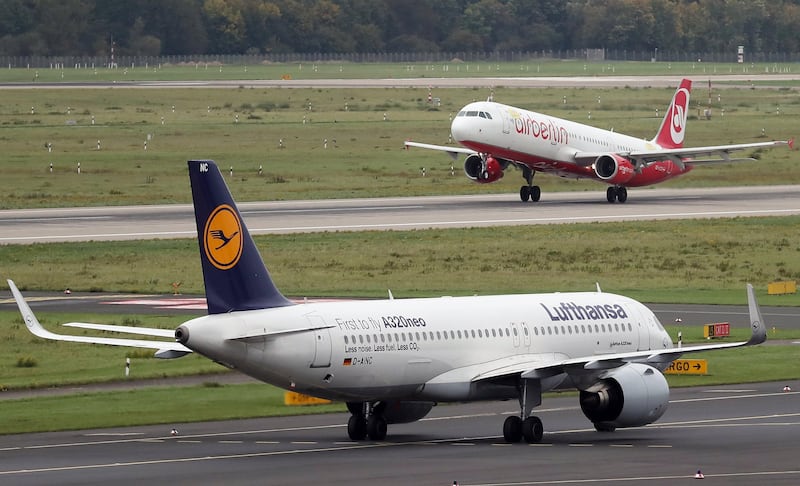 epa06260247 (FILE) - An aircraft of German carrier Air Berlin takes off behind a taxiing plane of German carrier Lufthansa at Duesseldorf Airport in Duesseldorf, Germany, 11 October 2017 (reissued 12 October 2017). German carrier Lufthansa on 12 October 2017 said it was signing a contract to buy 'large parts' of bankrupt carrier Air Berlin.  EPA/FRIEDEMANN VOGEL *** Local Caption *** 53824654