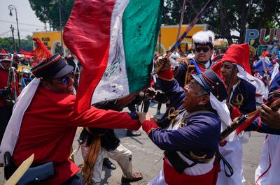 People participate in a re-enactment of the Battle of Puebla as part of Cinco de Mayo celebrations in Mexico City last year. AP