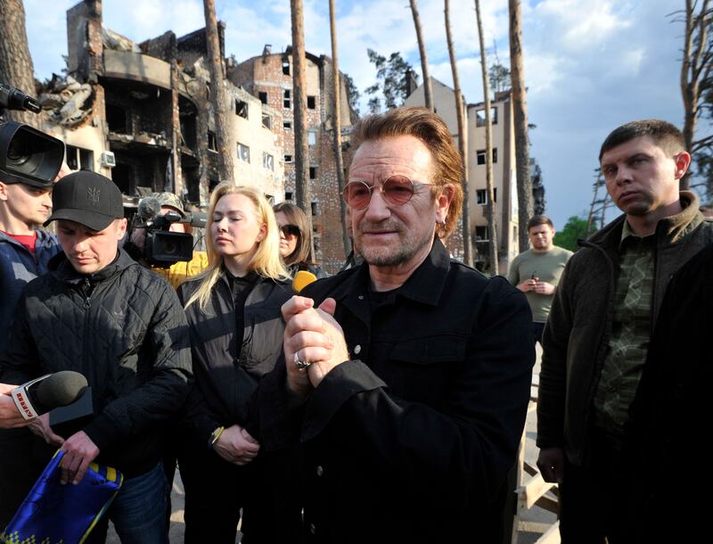 Bono greets people in Irpin. AFP