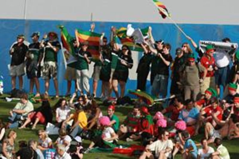 Zimbabwe fans wave flags in support of their team during yesterday's match against Wales.