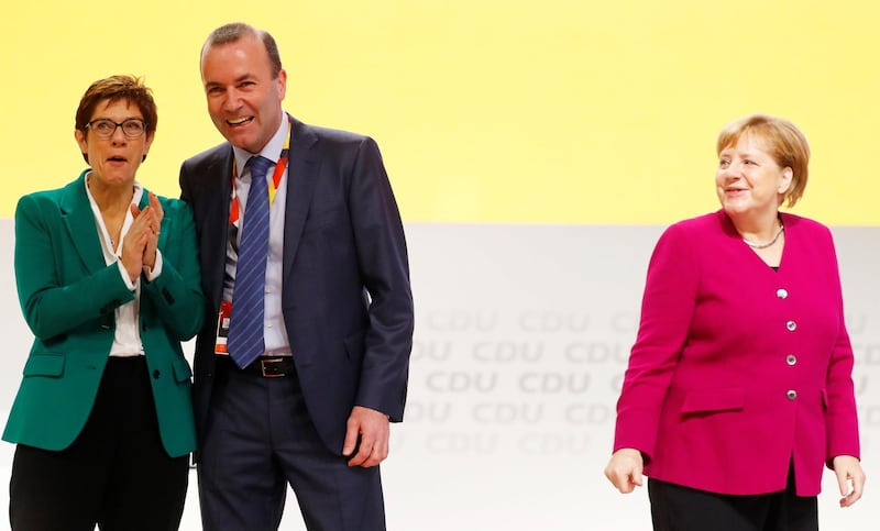 Manfred Weber of the Bavarian sister party CSU (Christian Social Union) appears on stage with newly elected CDU leader Annegret Kramp-Karrenbauer and German Chancellor and former leader of the party Angela Merkel, during the Christian Democratic Union (CDU) party congress in Hamburg, Germany, December 8, 2018. REUTERS/Kai Pfaffenbach