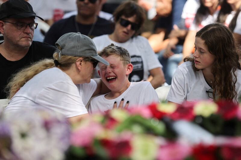 Shahar Idan, 9, mourns during the funeral of his brother Maayan, 18, who was killed by Hamas gunmen in the kibbutz of Nahal Oz. His father Tzahi is being held hostage in Gaza. Reuters