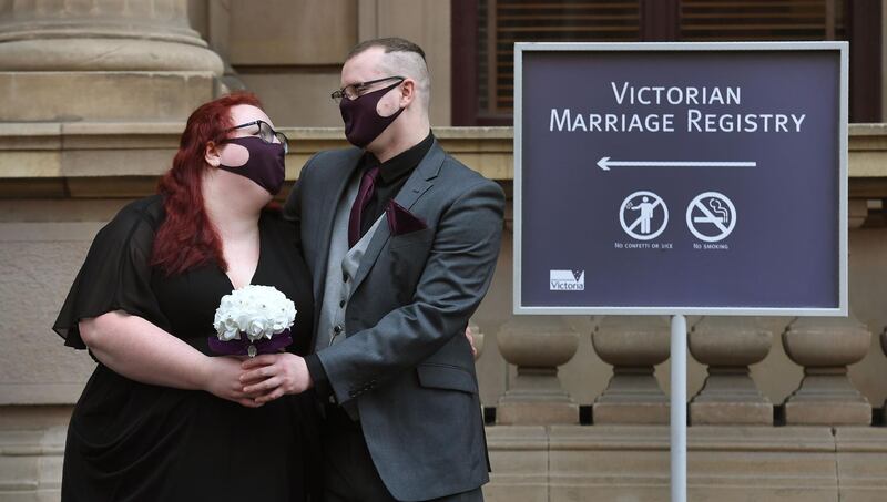 Anna and Ulf Crothers have their photo taken after marrying at the Victorian Marriage Registry in Melbourne, Australia, on the last day before weddings are banned in Melbourne for the next six weeks because of a new lockdown. AFP