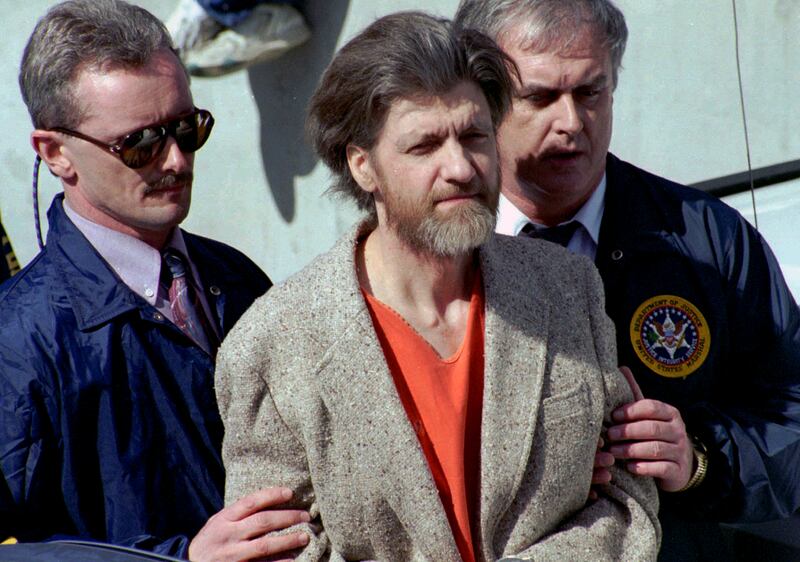 Ted Kaczynski, better known as the Unabomber, is escorted from a courthouse by US federal agents in 1996. AP