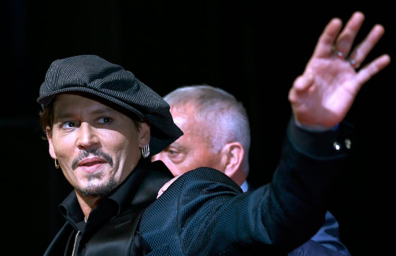 FILE - In this Tuesday, June 20, 2017, file photo, U.S. actor Johnny Depp waves for fans upon his arrival at a film premier in Tokyo. A new ad for a Dior men's fragrance called Sauvage, in which Depp appears, sparked outrage Friday, Aug. 30, 2019, for its use of Native American culture and symbols. (AP Photo/Shizuo Kambayashi, File)